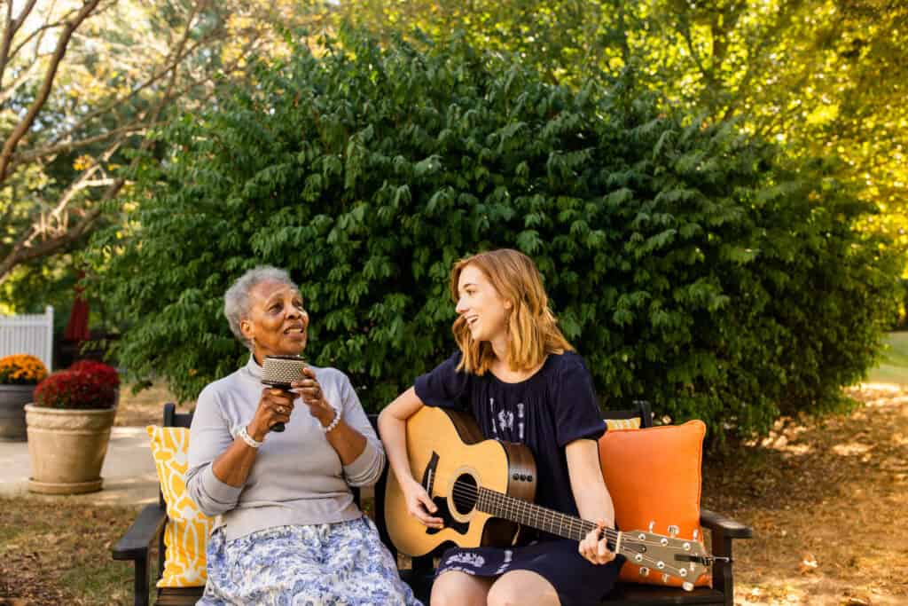 two ladies singing with a guitar