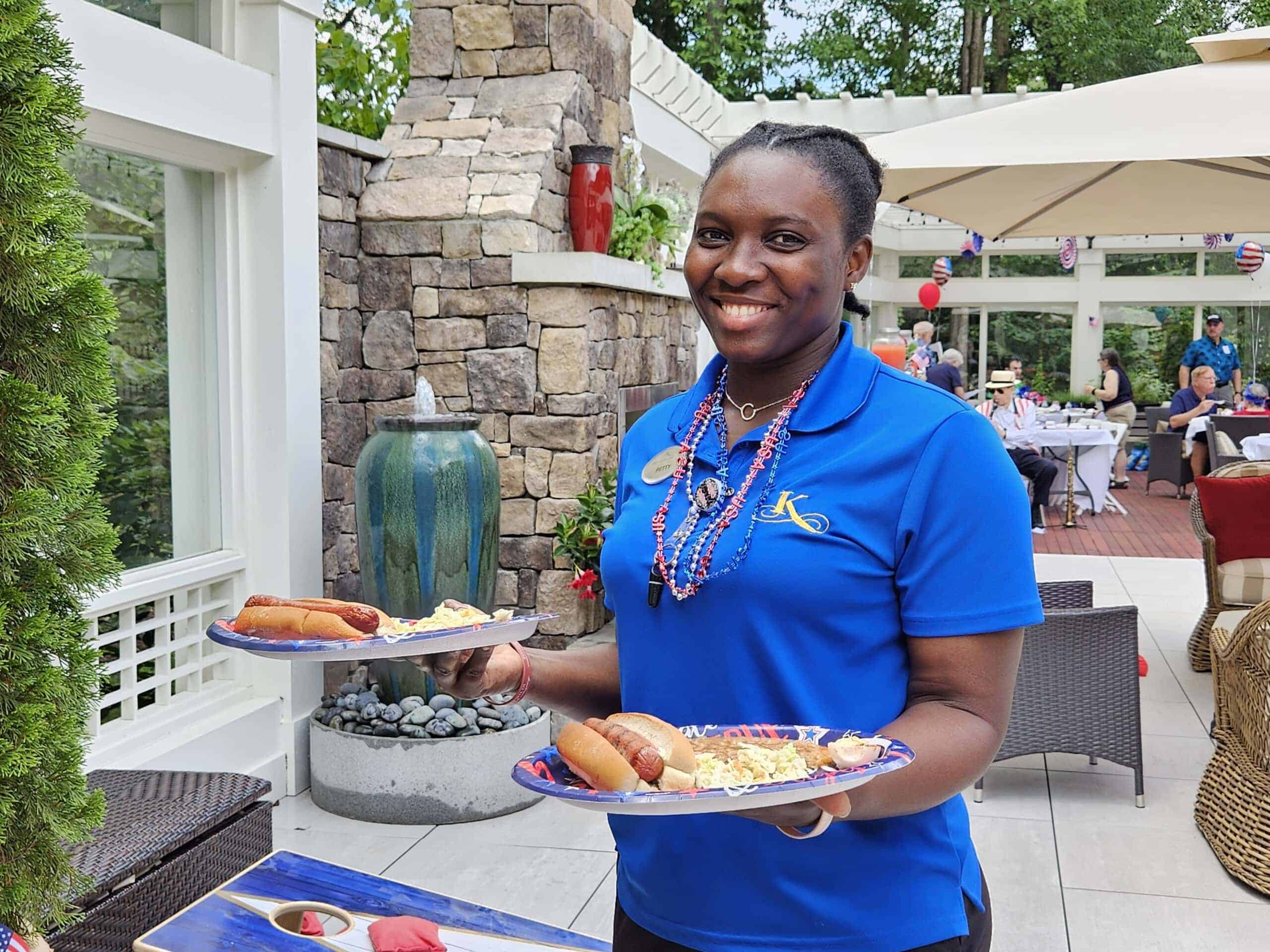 care team member with plates of food