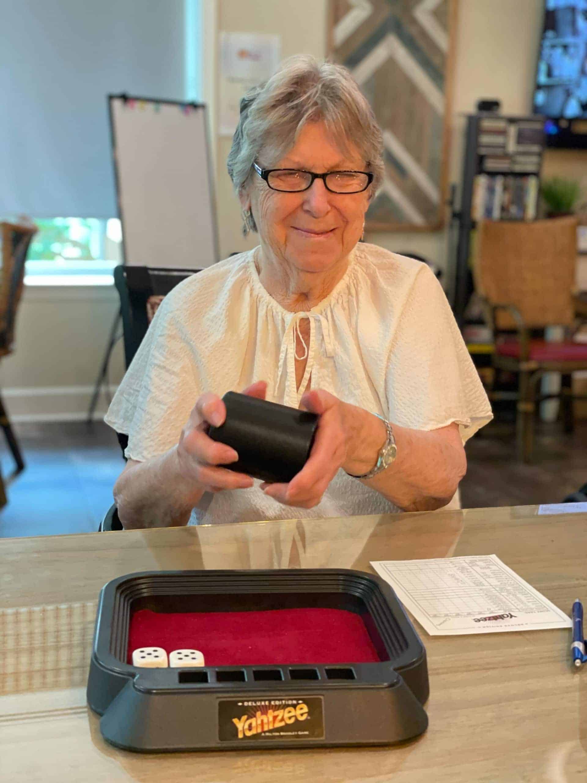 elderly resident woman playing Yahtzee