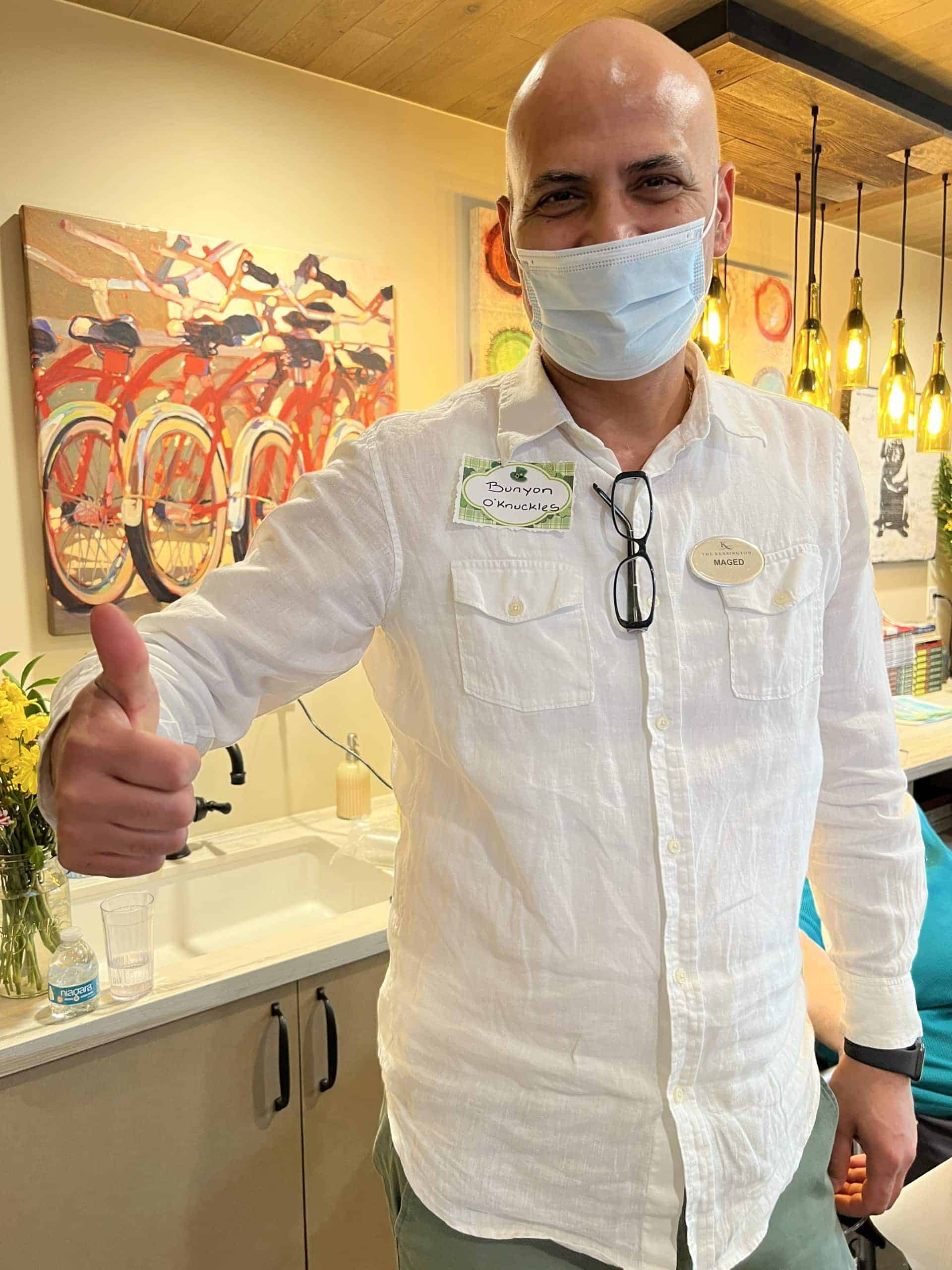 man team member smiling with thumbs up