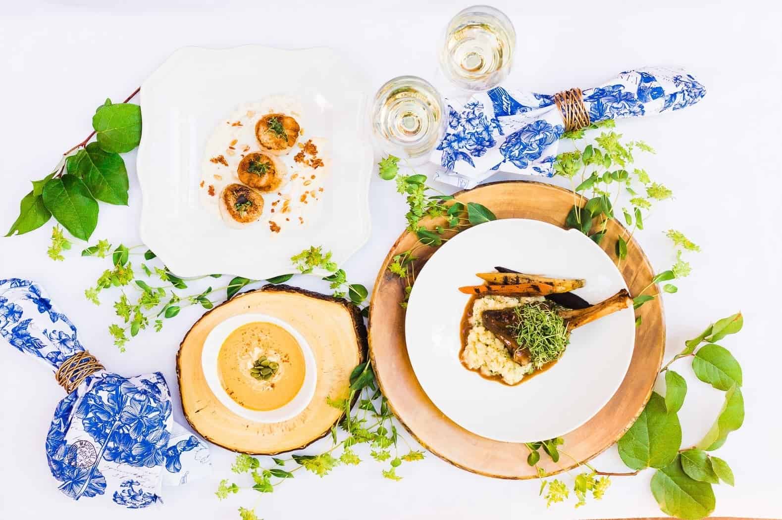 entree and soup set on table with wine