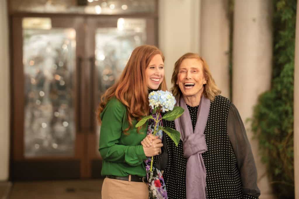 two women with flower